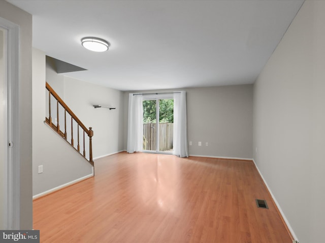 108 Bickel Ct, Sterling, VA 20165 - spare room with stairs, wood finished floors, and baseboards