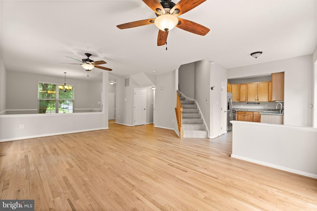 45620 Livingstone Station St, Sterling, VA 20166 - unfurnished living room with a ceiling fan, a chandelier, light wood finished floors, and stairway