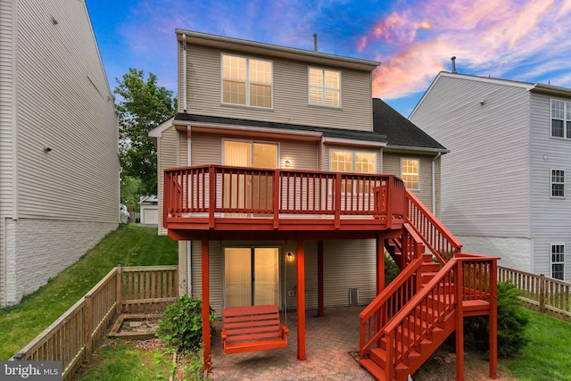 45620 Livingstone Station St, Sterling, VA 20166 - back of house at dusk featuring a wooden deck, a fenced backyard, a patio, and stairs