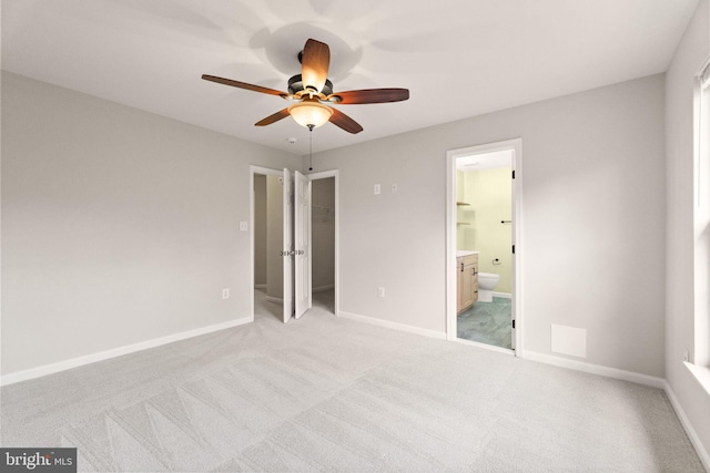 45620 Livingstone Station St, Sterling, VA 20166 - unfurnished bedroom with light carpet, ensuite bathroom, a walk in closet, and baseboards