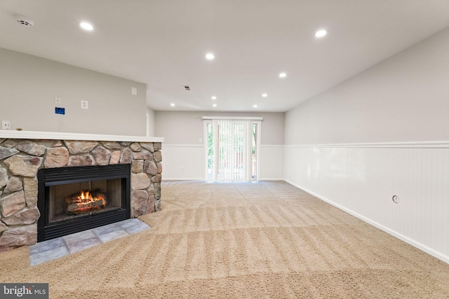 45620 Livingstone Station St, Sterling, VA 20166 - unfurnished living room featuring a stone fireplace, wainscoting, recessed lighting, and carpet flooring