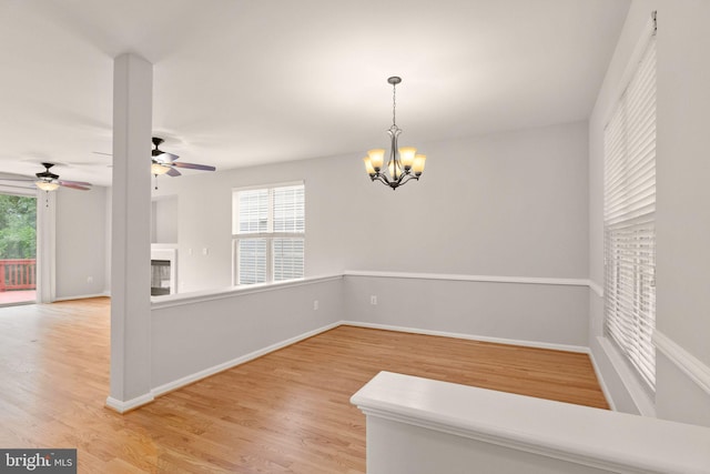 45620 Livingstone Station St, Sterling, VA 20166 - empty room featuring a chandelier, light wood-style flooring, a ceiling fan, and baseboards