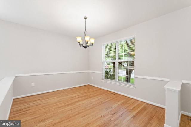 45620 Livingstone Station St, Sterling, VA 20166 - unfurnished room featuring a chandelier, wood finished floors, and baseboards