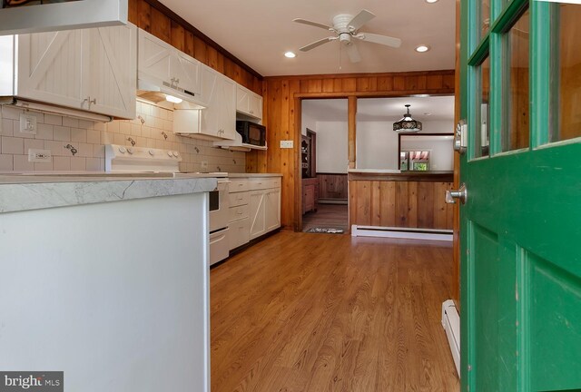 172 Chippewa Trl, Medford Lakes, NJ 08055 - kitchen featuring electric range, black microwave, baseboard heating, white cabinetry, and light wood-type flooring