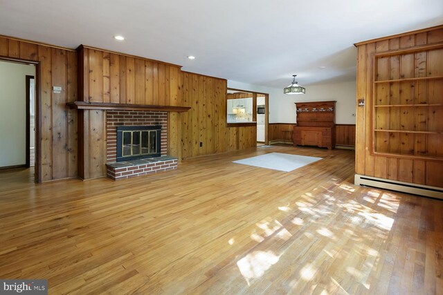 172 Chippewa Trl, Medford Lakes, NJ 08055 - unfurnished living room featuring light wood-style floors, wooden walls, a baseboard radiator, recessed lighting, and a fireplace