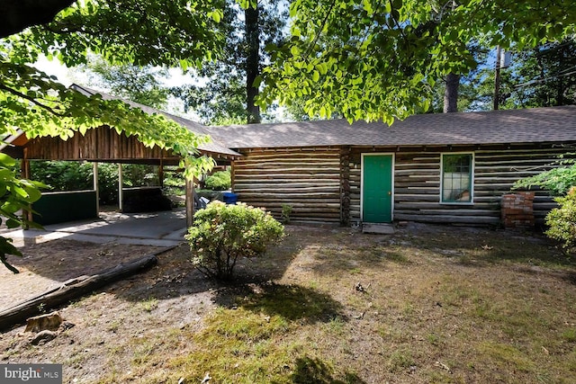 172 Chippewa Trl, Medford Lakes, NJ 08055 - rear view of property with log exterior, a shingled roof, and a carport