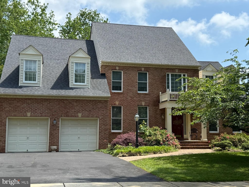 244 Ebb Point Ln, Annapolis, MD 21401 - view of front facade with driveway, an attached garage, a shingled roof, brick siding, and a front lawn