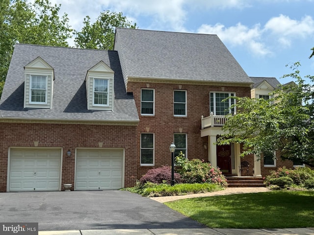 244 Ebb Point Ln, Annapolis, MD 21401 - view of front facade with driveway, an attached garage, a shingled roof, brick siding, and a front lawn