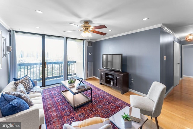 living room featuring ornamental molding, light wood-type flooring, ceiling fan, baseboards, and recessed lighting