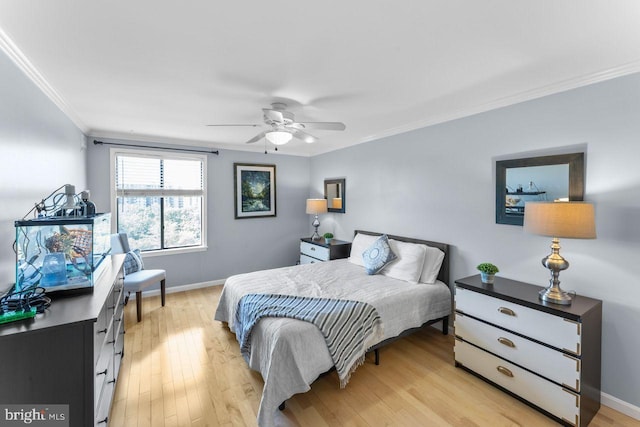 bedroom featuring ornamental molding, baseboards, light wood finished floors, and a ceiling fan