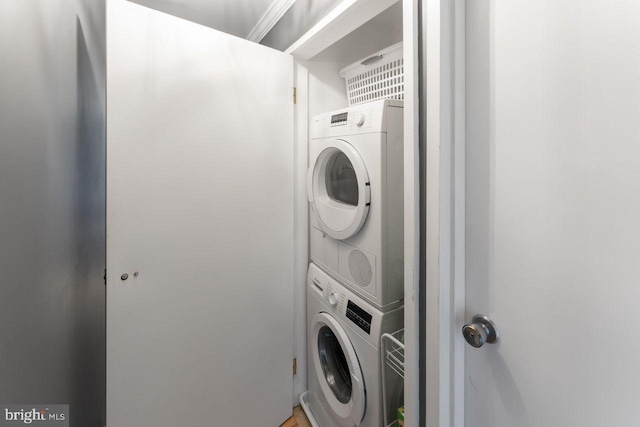 laundry room with stacked washer and clothes dryer