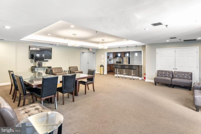 dining room with a raised ceiling, baseboards, carpet, and recessed lighting