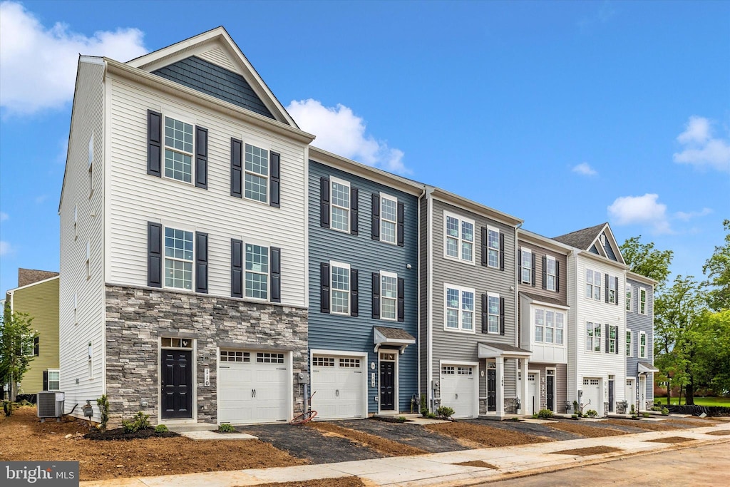 108 Spring Bank Way, Frederick, MD 21701 - view of property with central AC, stone siding, driveway, and a garage