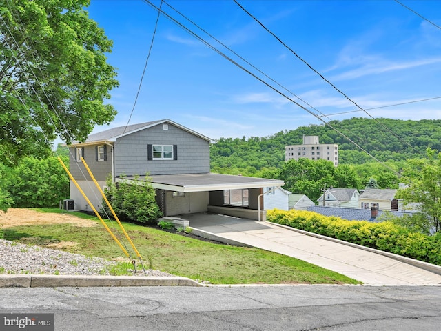 20 E Market St, Schuylkill Haven, PA 17972 - view of front of home with concrete driveway, a front lawn, a carport, and cooling unit