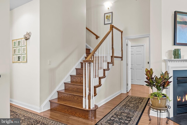 230 Bobwhite Rd, New Hope, PA 18938 - entryway with a fireplace with flush hearth, wood finished floors, stairway, and baseboards