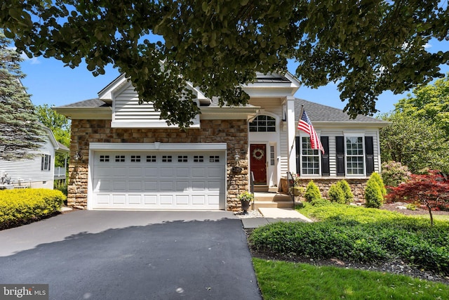 230 Bobwhite Rd, New Hope, PA 18938 - view of front facade featuring stone siding, driveway, an attached garage, and roof with shingles