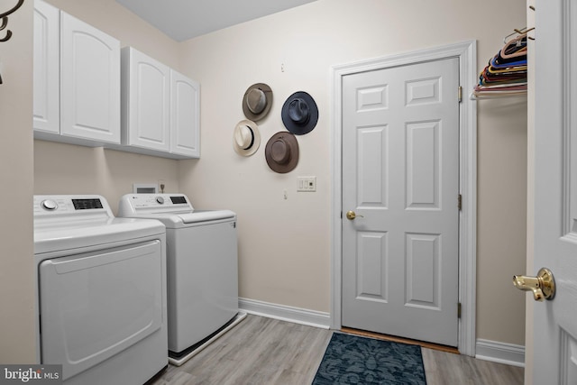 230 Bobwhite Rd, New Hope, PA 18938 - washroom featuring cabinet space, washer and dryer, light wood-type flooring, and baseboards