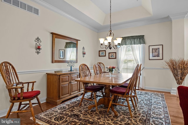 230 Bobwhite Rd, New Hope, PA 18938 - dining space with light wood-style flooring, a chandelier, ornamental molding, baseboards, and a tray ceiling