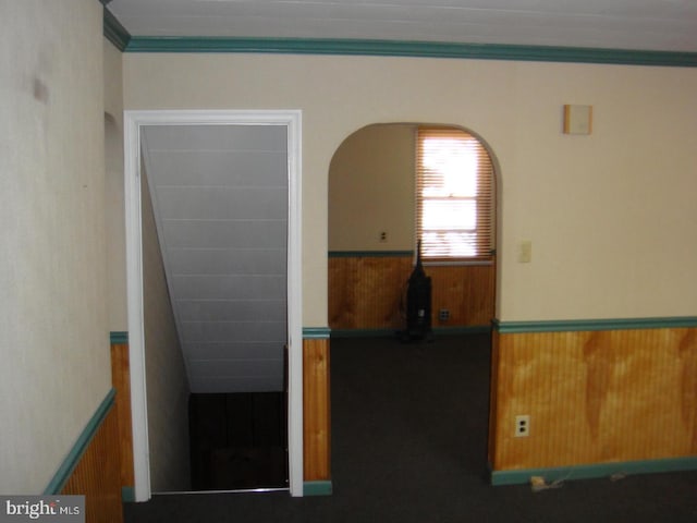 4312 Fritchey St, Lower Paxton, PA 17109 - unfurnished room with a wainscoted wall, crown molding, wooden walls, and arched walkways