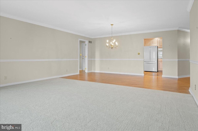 3203 Falcon Ln Ste 311, Wilmington, DE 19808 - empty room featuring a chandelier, light carpet, ornamental molding, baseboards, and light wood-type flooring