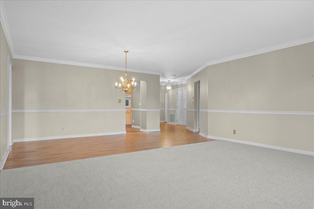 3203 Falcon Ln Ste 311, Wilmington, DE 19808 - unfurnished room featuring a chandelier, light carpet, light wood finished floors, baseboards, and crown molding