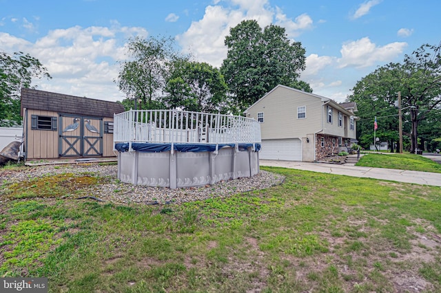 1627 Kindle Ave, Deptford, NJ 08096 - view of green lawn featuring a covered pool, a garage, and concrete driveway