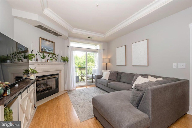 2500 Waterside Dr Unit 110, Frederick, MD 21701 - living room with a fireplace, a raised ceiling, light wood-style floors, and crown molding