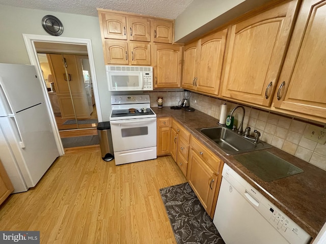 666 W Germantown Pike Unit 1721, Plymouth Meeting, PA 19462 - kitchen featuring white appliances, a sink, light wood-type flooring, dark countertops, and backsplash
