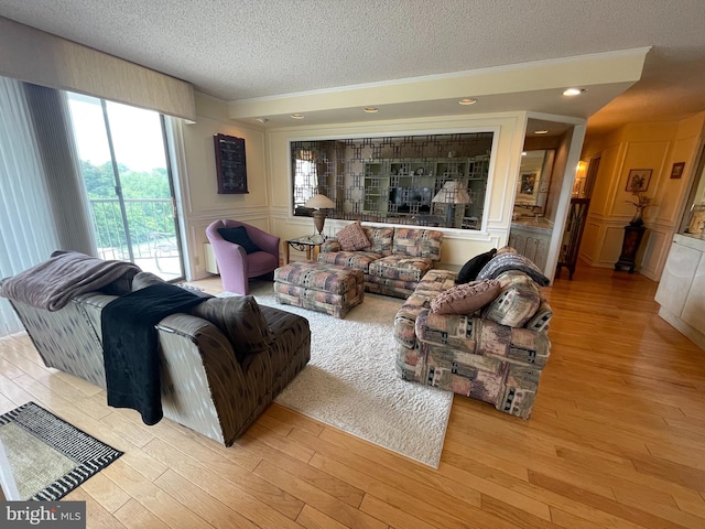 666 W Germantown Pike Unit 1721, Plymouth Meeting, PA 19462 - living area with a textured ceiling, a decorative wall, and wood finished floors