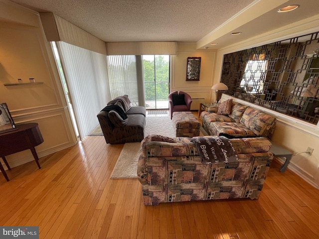 666 W Germantown Pike Unit 1721, Plymouth Meeting, PA 19462 - living area featuring a textured ceiling and hardwood / wood-style floors