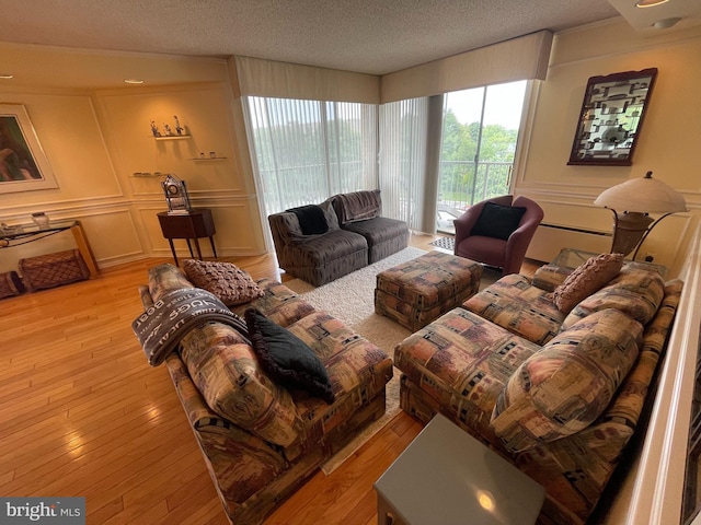 666 W Germantown Pike Unit 1721, Plymouth Meeting, PA 19462 - living room with a decorative wall, a textured ceiling, and light wood-type flooring