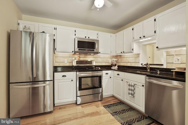 6072 Old Landing Way Unit 48, Burke, VA 22015 - kitchen with stainless steel appliances, ceiling fan, white cabinetry, and light wood-style floors