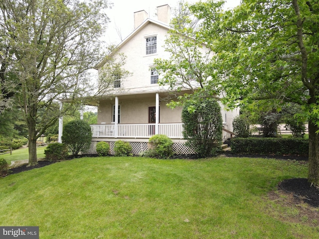4560 Bossler Rd, Elizabethtown, PA 17022 - back of house featuring stucco siding, a chimney, a lawn, and a porch