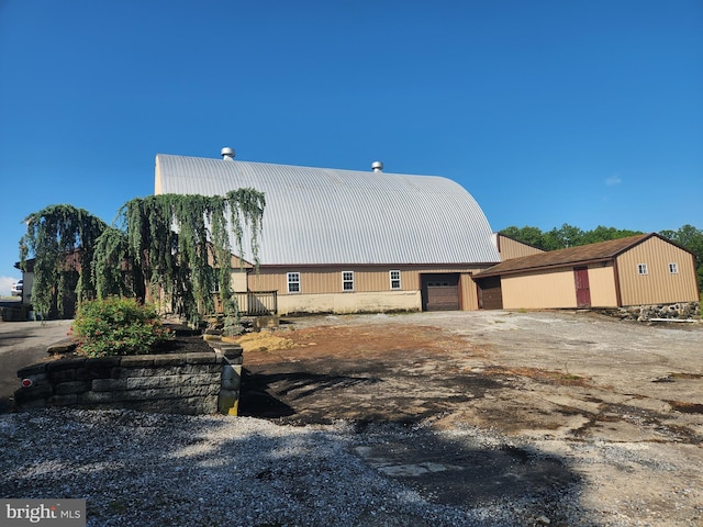 4560 Bossler Rd, Elizabethtown, PA 17022 - view of side of property featuring metal roof, an outbuilding, and a garage