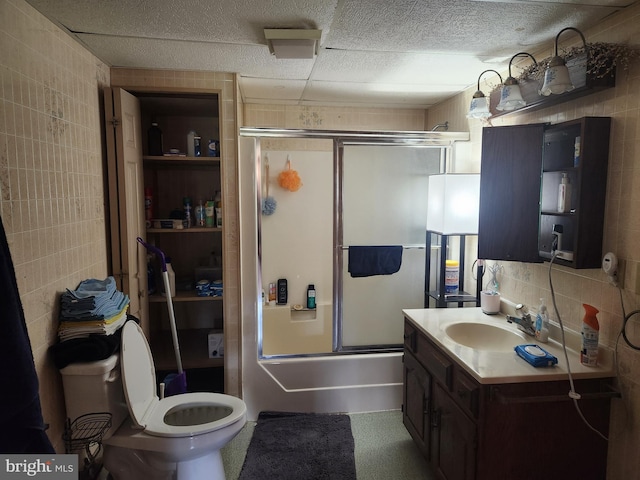 4560 Bossler Rd, Elizabethtown, PA 17022 - bathroom with tile walls, vanity, shower / bath combination with glass door, and toilet