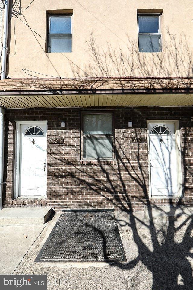 1702 N 2nd St, Philadelphia, PA 19122 - view of side of home with brick siding and stucco siding