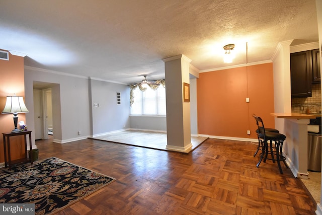 80 W Baltimore Ave, Lansdowne, PA 19050 - kitchen featuring baseboards, crown molding, a ceiling fan, a textured ceiling, and dark brown cabinets