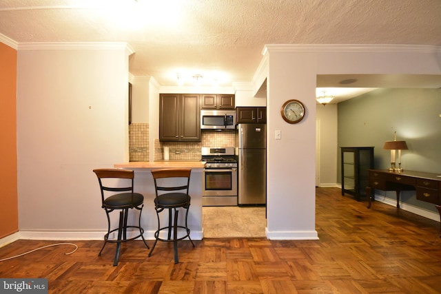 80 W Baltimore Ave, Lansdowne, PA 19050 - kitchen with stainless steel appliances, a kitchen breakfast bar, tasteful backsplash, a peninsula, and light countertops