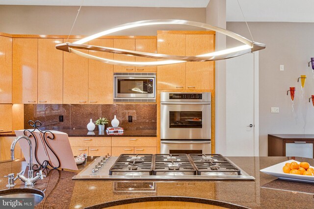 918 Centrillion Dr, Mclean, VA 22102 - kitchen with appliances with stainless steel finishes, a sink, decorative backsplash, and dark stone counters