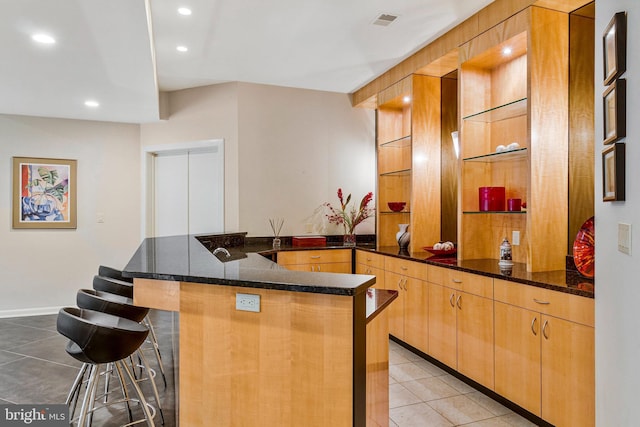 918 Centrillion Dr, Mclean, VA 22102 - kitchen with light tile patterned floors, a peninsula, a kitchen breakfast bar, dark stone counters, and recessed lighting