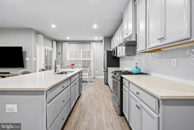 1528 Catbriar Way, Odenton, MD 21113 - kitchen with stainless steel appliances, a sink, an island with sink, tasteful backsplash, and light wood-type flooring