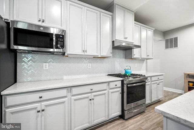 1528 Catbriar Way, Odenton, MD 21113 - kitchen with appliances with stainless steel finishes, under cabinet range hood, light wood-style floors, tasteful backsplash, and light stone countertops