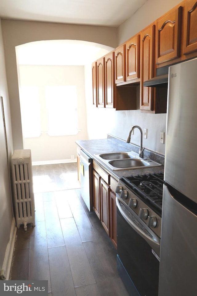 1235 Owen Pl NE, Washington, DC 20002 - kitchen with appliances with stainless steel finishes, radiator, and dark wood-type flooring