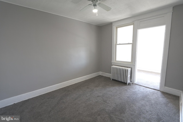 1235 Owen Pl NE, Washington, DC 20002 - spare room featuring radiator heating unit, dark colored carpet, ceiling fan, and a textured ceiling
