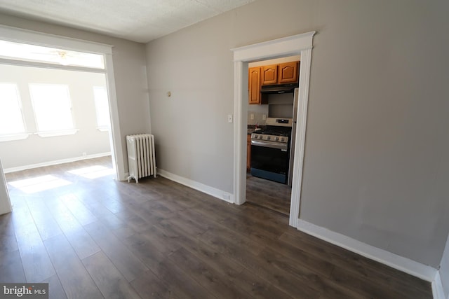 1235 Owen Pl NE, Washington, DC 20002 - spare room featuring radiator and dark wood-style floors