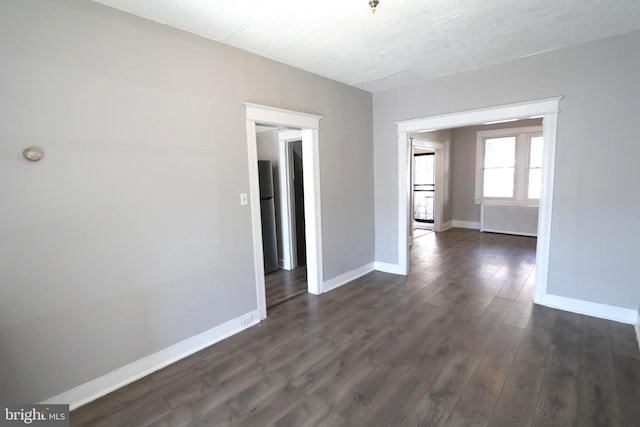 1235 Owen Pl NE, Washington, DC 20002 - spare room featuring dark wood-type flooring and a textured ceiling