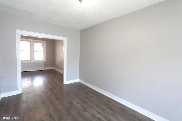 1235 Owen Pl NE, Washington, DC 20002 - spare room featuring dark wood finished floors and a textured ceiling