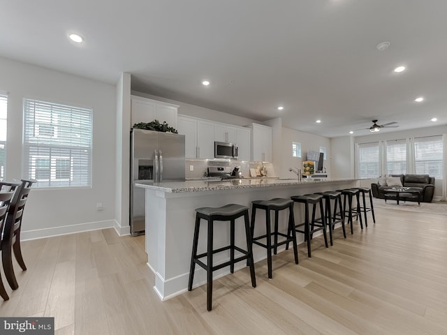 45375 Concord Way, California, MD 20619 - kitchen featuring appliances with stainless steel finishes, light wood-style floors, plenty of natural light, tasteful backsplash, and recessed lighting