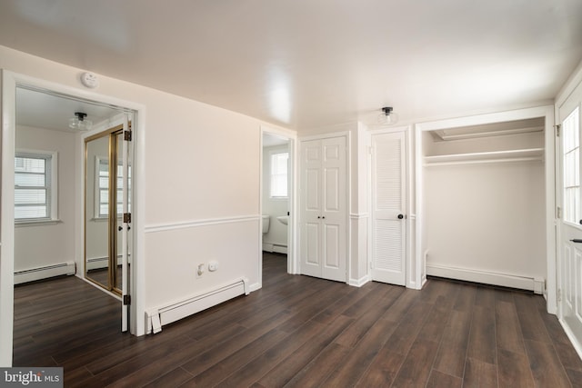 218 Elizabeth St, Bordentown, NJ 08505 - unfurnished bedroom featuring baseboard heating, a baseboard heating unit, and dark wood-style flooring