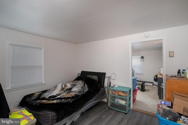 218 Elizabeth St, Bordentown, NJ 08505 - bedroom featuring a baseboard heating unit and wood finished floors